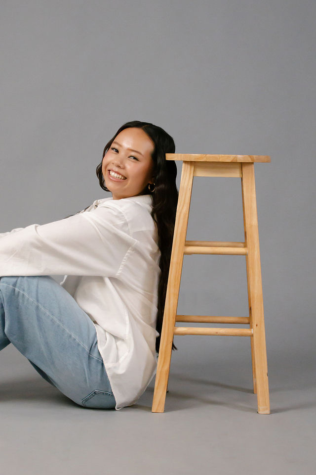 Arianna Luong smiling warmly during a studio portrait session